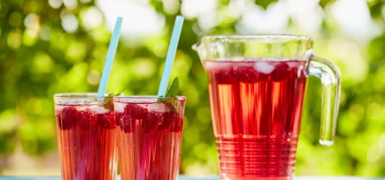 Raspberry lemonade with pitcher and glasses