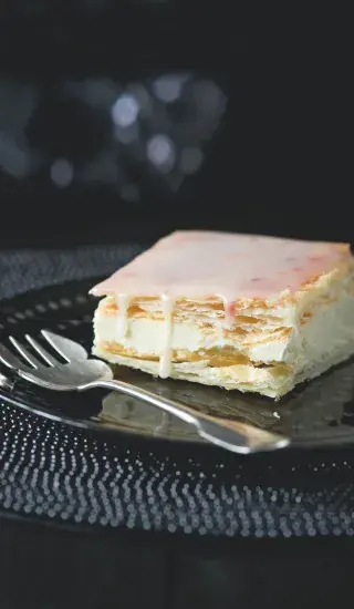 Slice of layered cake with cream and pastry sheets