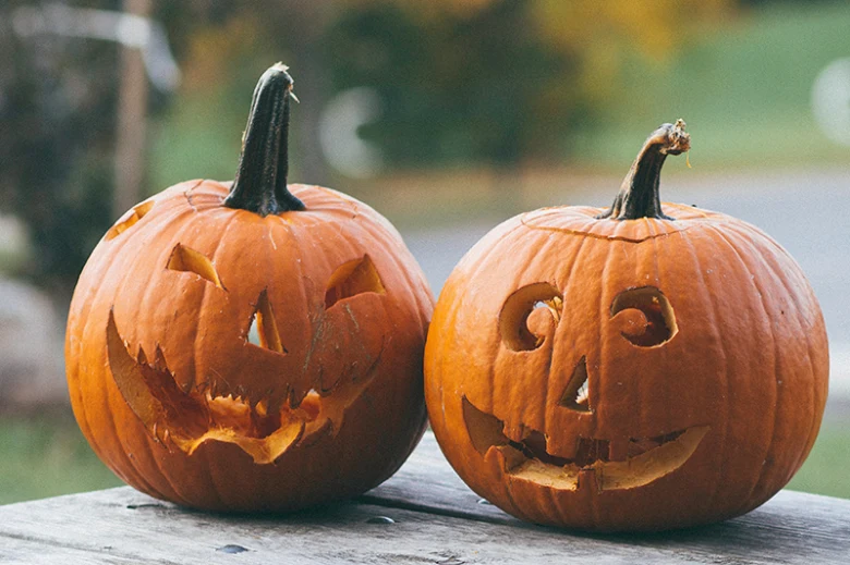 Carved pumpkins on wood